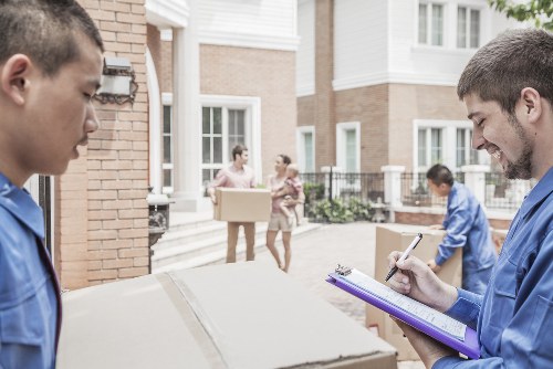Movers planning a home relocation on a residential street in Ealing