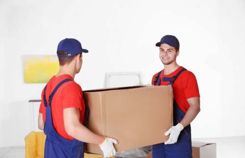 Local removals team unloading boxes and furniture at a new Ealing property