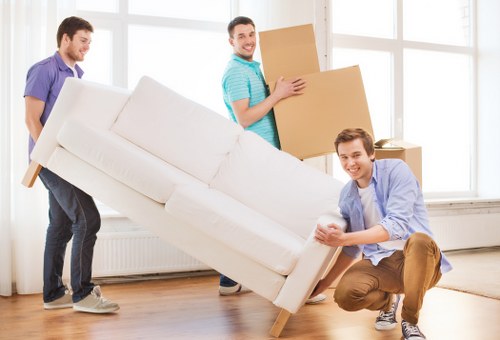 Professional furniture pick-up team handling heavy items