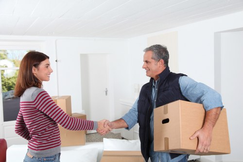 Local movers unpacking essentials in an Ealing property