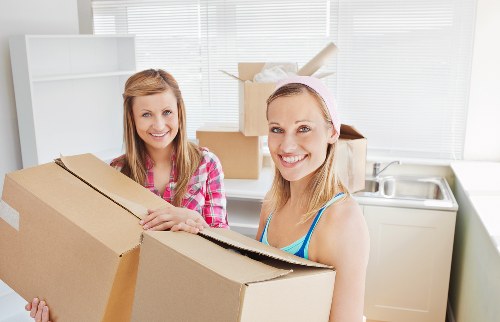 Commercial moving team handling office furniture and boxes